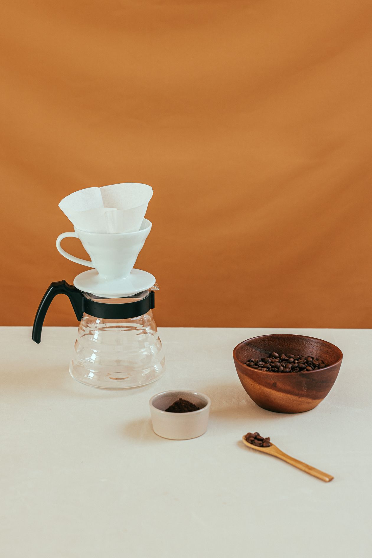 Minimalist home coffee setup with pour-over brewer and fresh coffee beans — home coffee setup for beginners