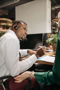 A dedicated call center professional offering customer support while using headphones.