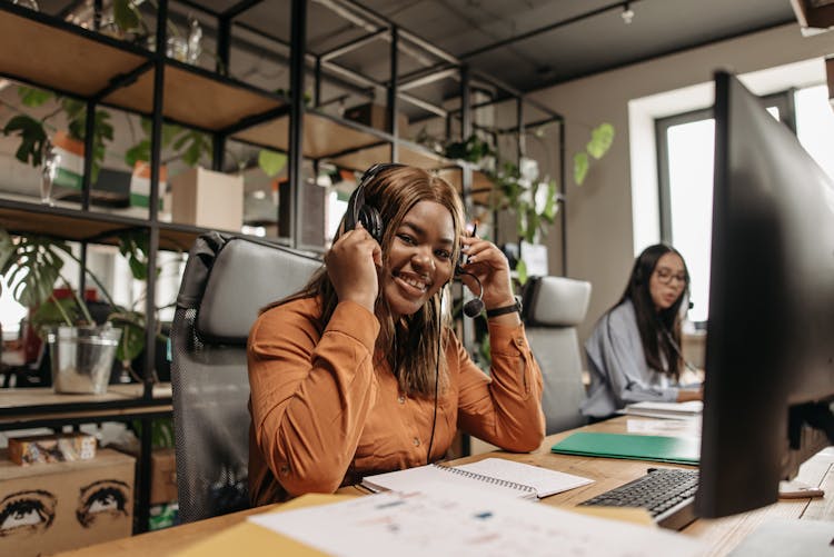 Woman In Brown Long Sleeve Shirt With Headset