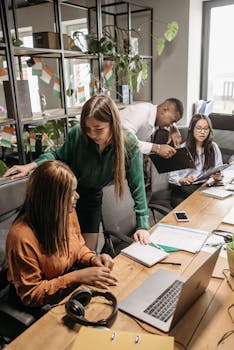 A multicultural team working together in a modern office environment, fostering collaboration and innovation.