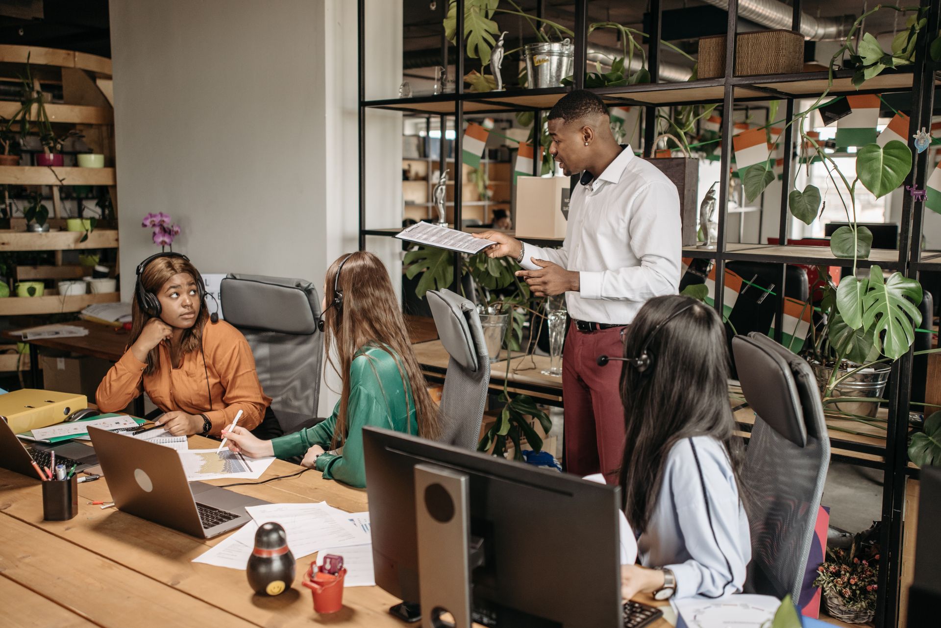 Diverse group of call center agents collaborating in a modern office space.