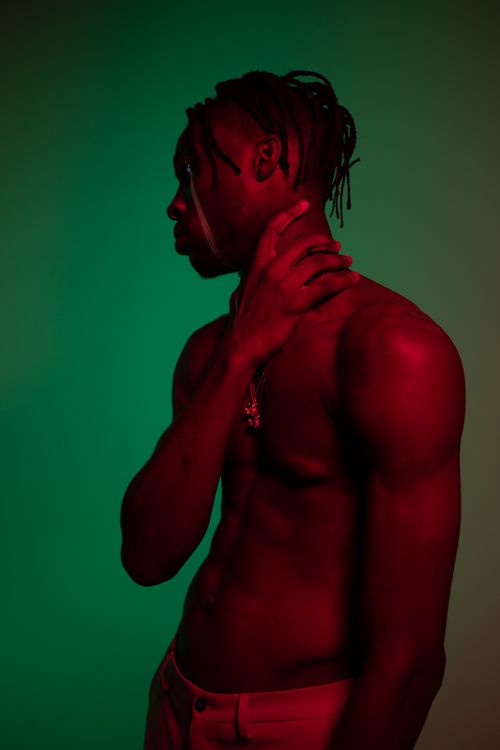 A Shirtless Man Holding His Neck · Free Stock Photo