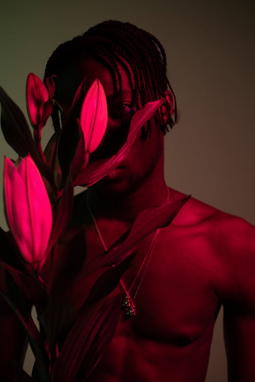 A Man Covering his Face with the Flowers