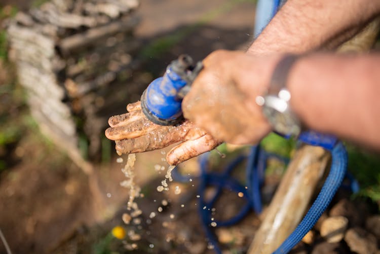 Close-Up Shot Of A Person Washing Dirty Hand 