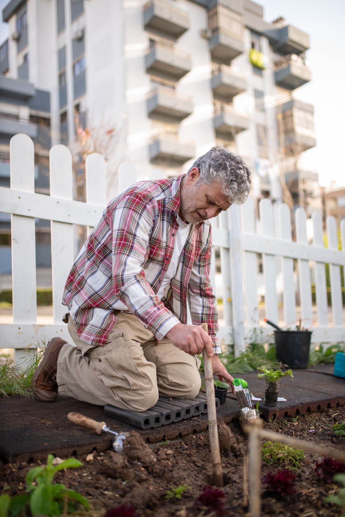 Senior Arizona homeowner gardening at home, weighing alternatives to a reverse mortgage