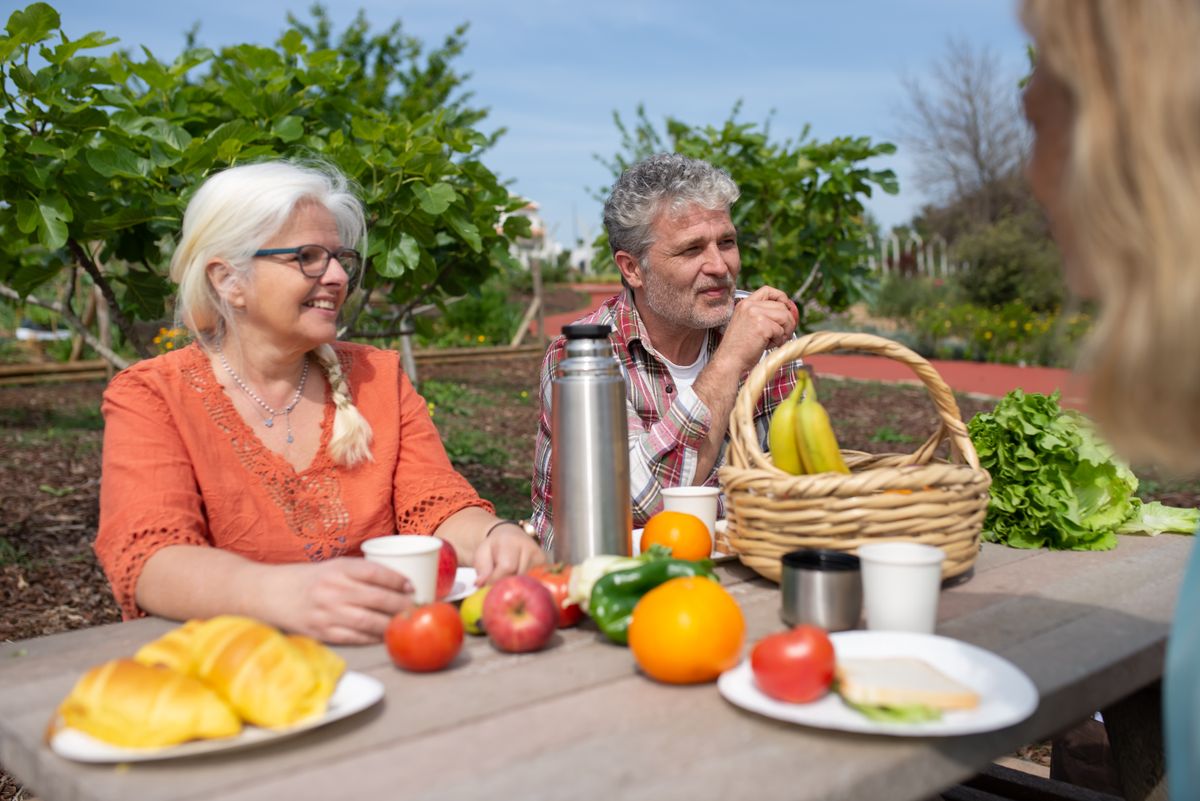 Older adults enjoying time together outdoors in a wellness garden setting