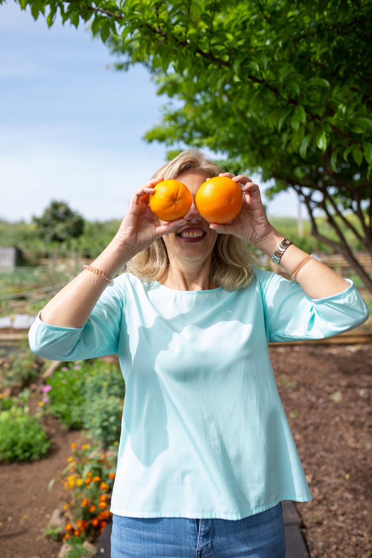 Woman Covering Eyes With Fruits