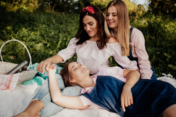 Women Resting On Picnic Blanket