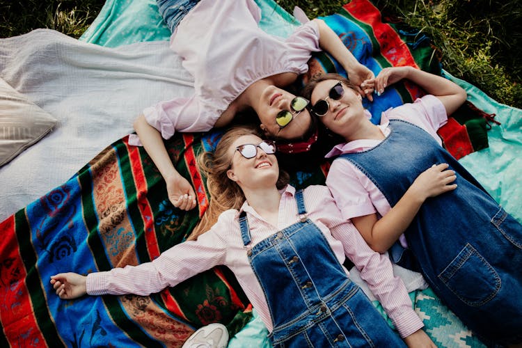 Women In Sunglasses Lying Down On Blanket