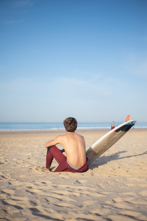 A Person Sitting on the Sand · Free Stock Photo