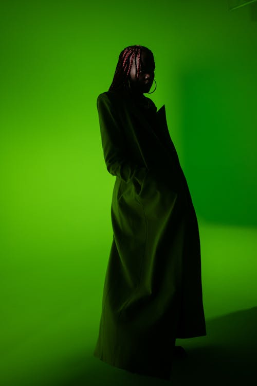 Woman in Coat on Green Background