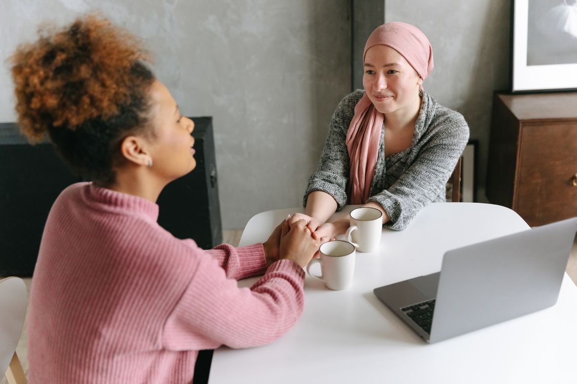 A Woman Holding her Hands with her Friend