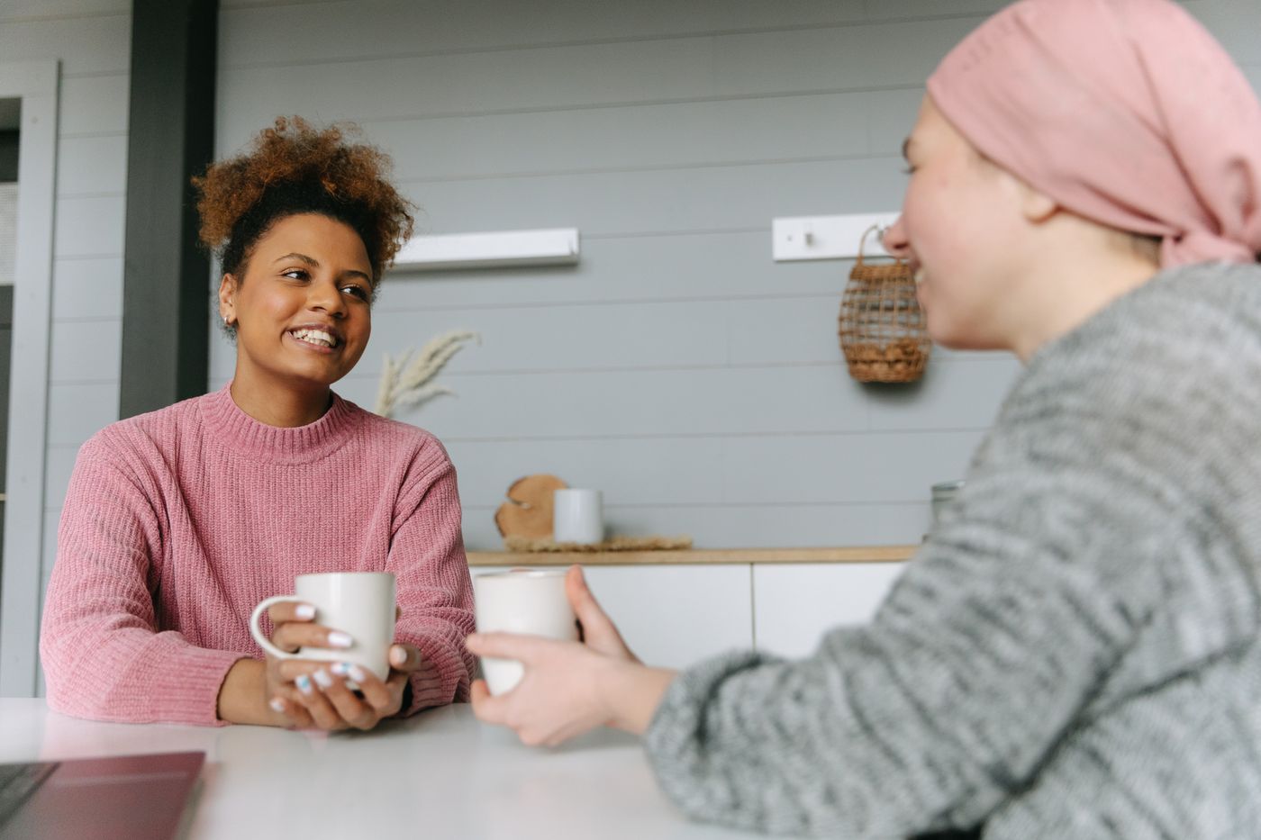 Two people sharing a conversation over coffee