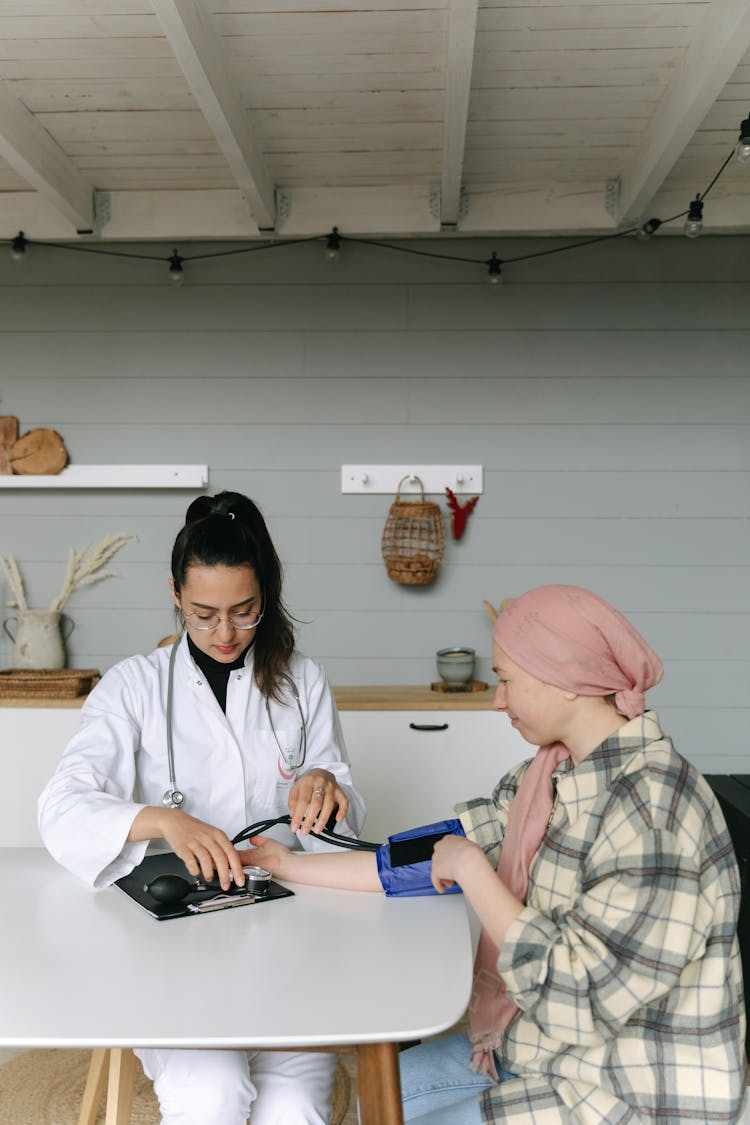 A Doctor Checking A Woman's Blood Pressure