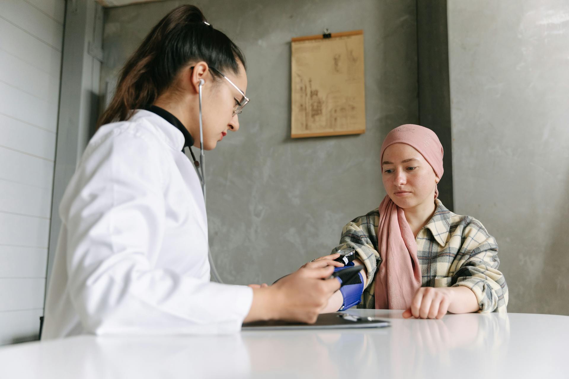 A Doctor Taking The Woman's Blood Pressure