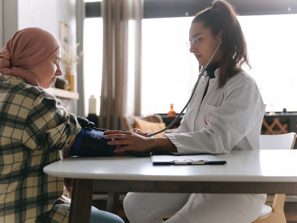 Healthcare professional measuring blood pressure