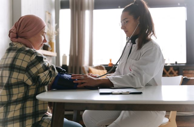 Healthcare professional measuring blood pressure