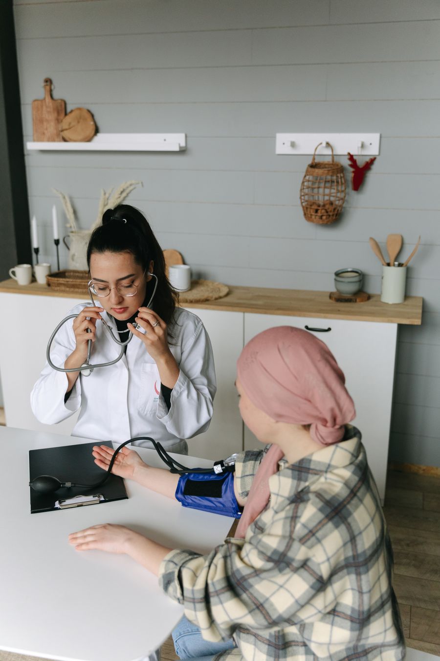 Indian caregiver assisting a patient at home