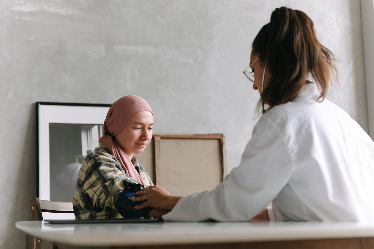 Person holding a pen needle near the abdomen, preparing for an injection