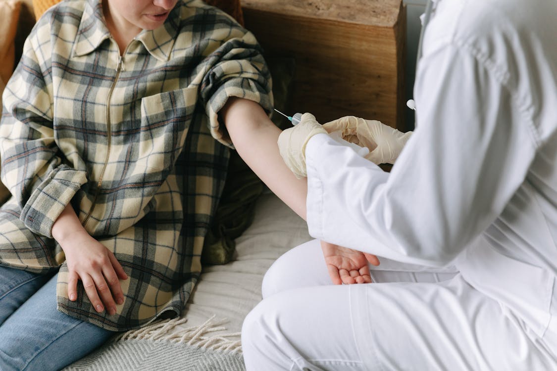 A Doctor Giving her Patient an Injection Medicine