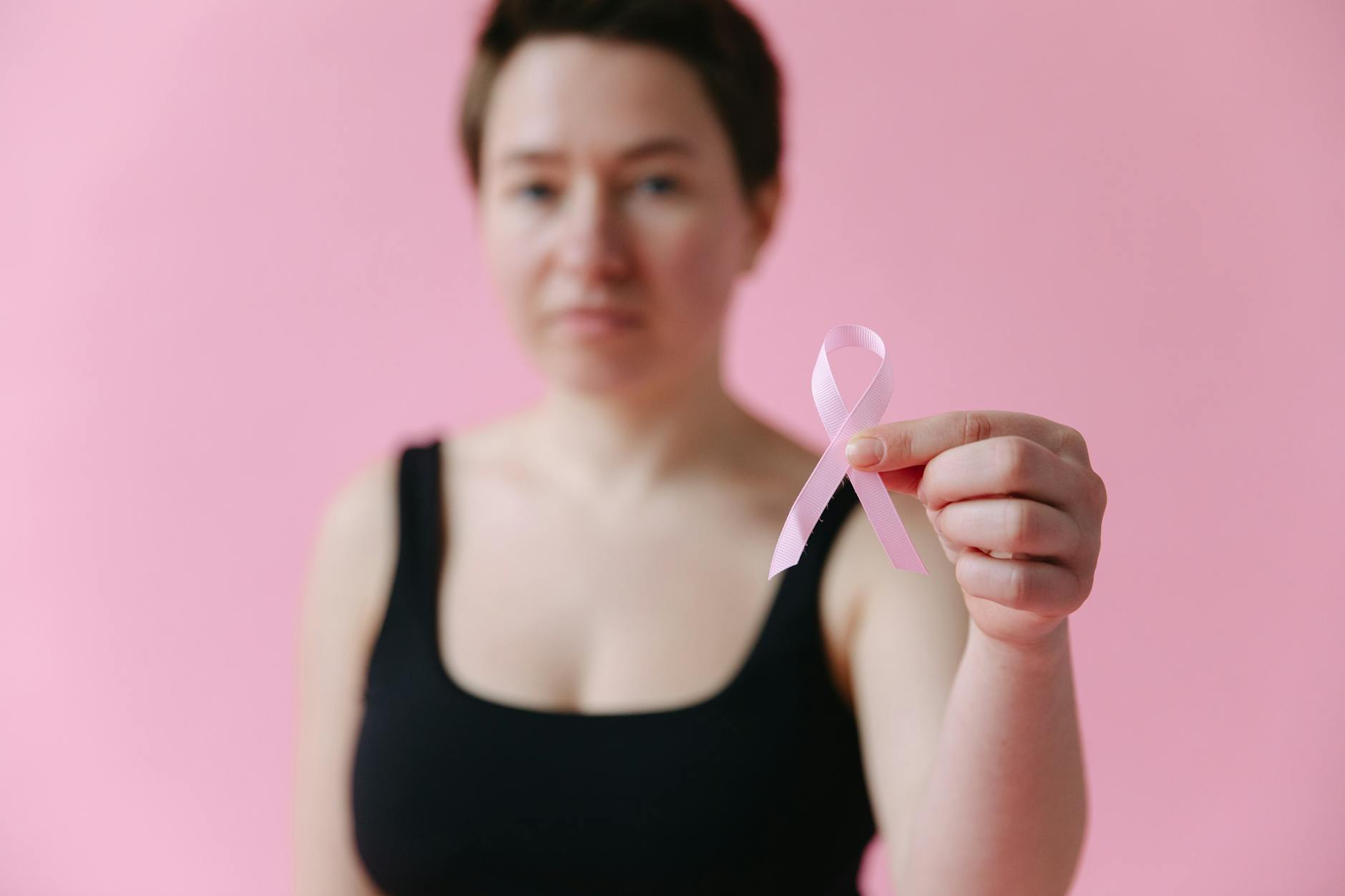 A Woman Holding a Pink Ribbon