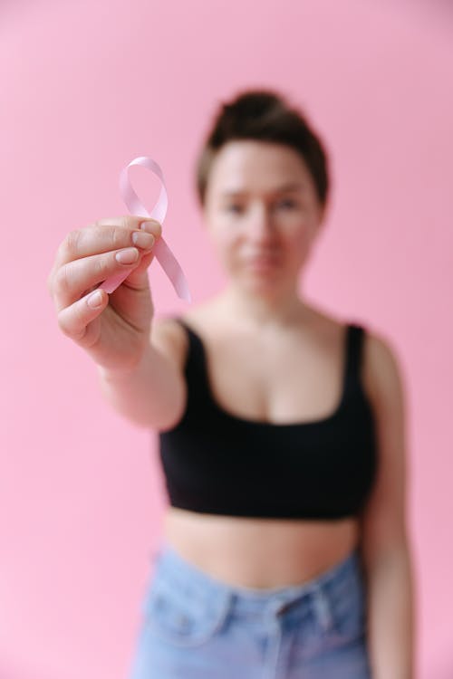 Free A Person Holding a Pink Ribbon Stock Photo