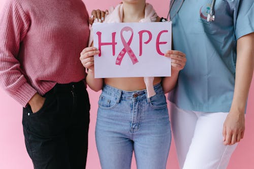 Free People with a Person Holding a Breast Cancer Awareness Placard Stock Photo