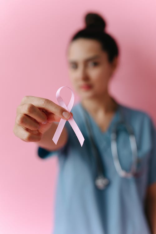 A Doctor Holding a Pink Ribbon