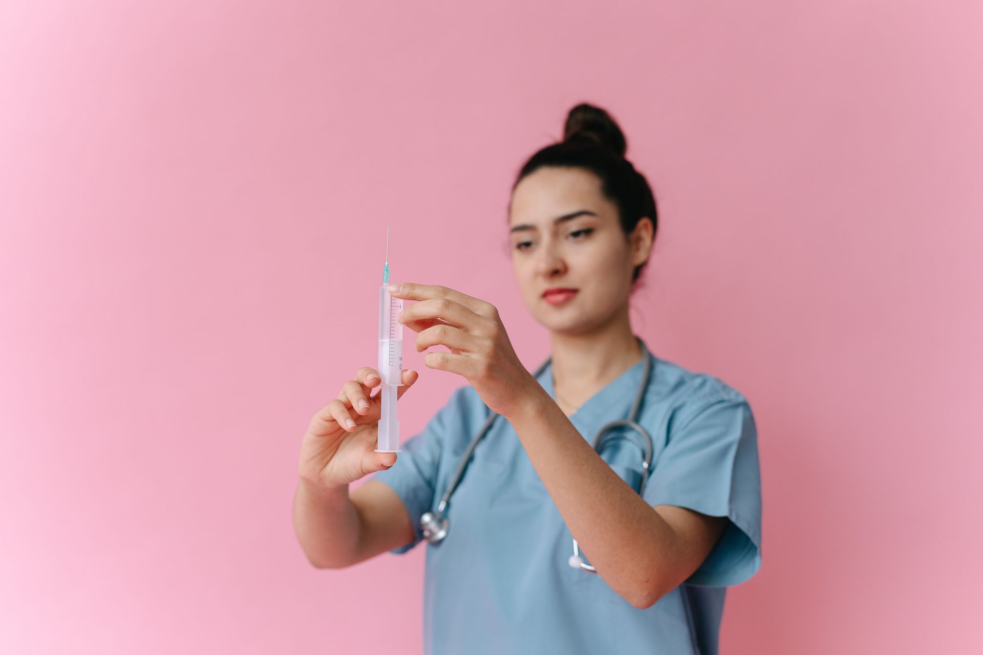 A health worker preparing a vaccine at a clinic