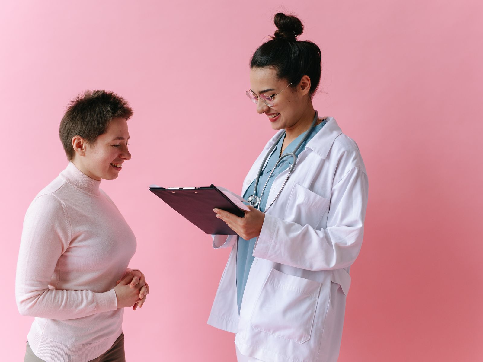 Doctor speaking with a smiling patient during a consultation