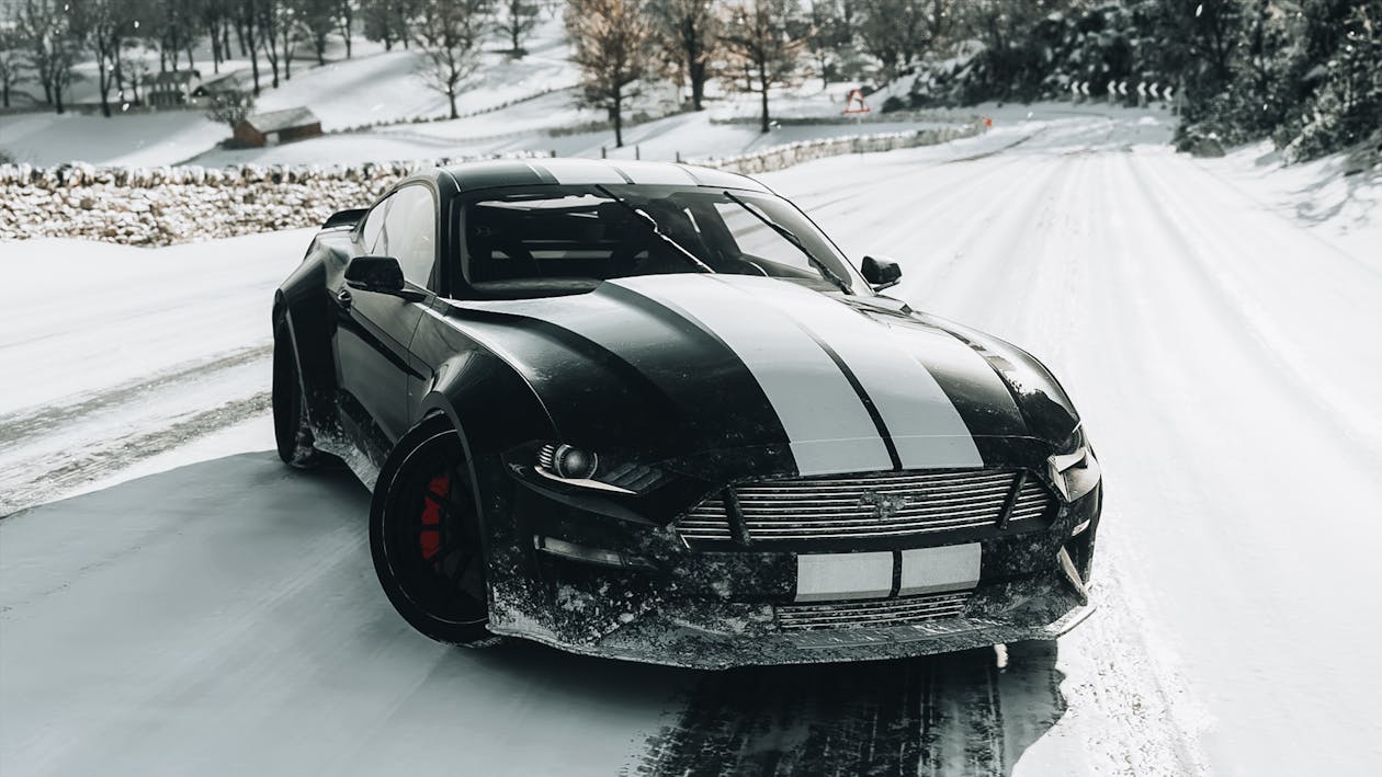 A Black and White Ford Shelby Mustang on Snow-Covered Road