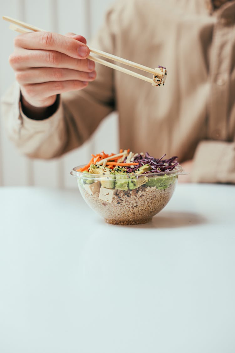 Person Eating A Rice Bowl