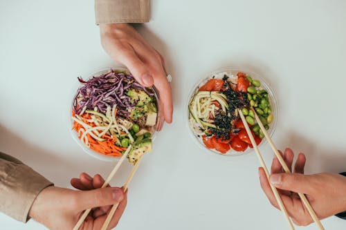 Person Holding White Ceramic Bowl With Vegetable Salad