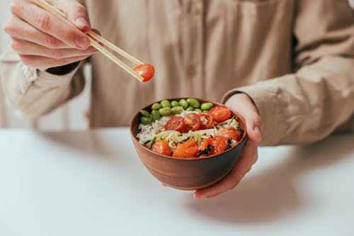 Person Holding a Vegetable Rice Bowl