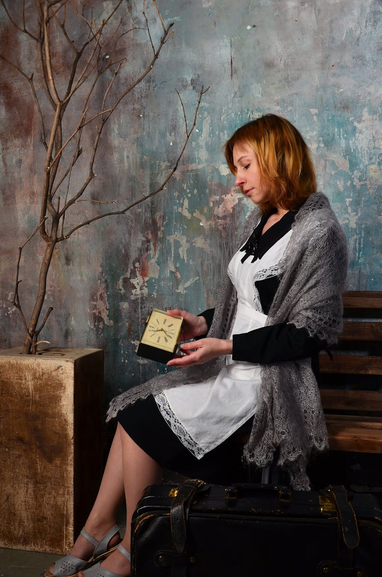 A Maid Checking The Time On A Clock