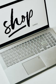 A focused image of a laptop displaying 'shop small' on the screen, promoting small businesses.
