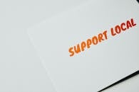 A Support Local Text on a White Paper