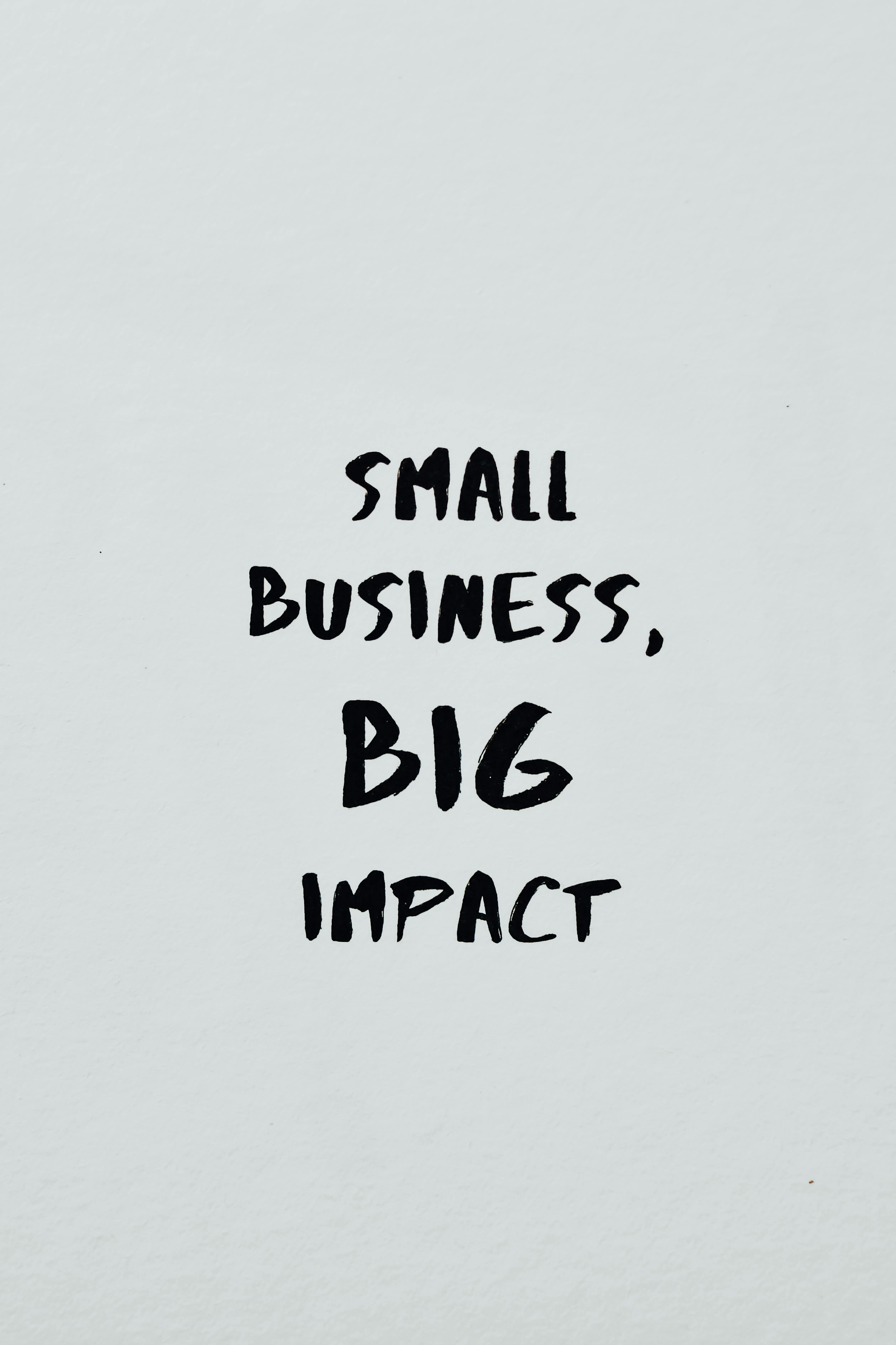 Small Business Big Impact Text On A White Surface · Free Stock Photo