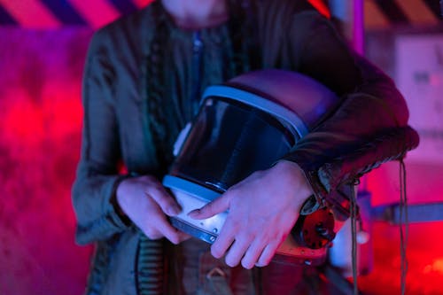 Free Person In Spacesuit Holding A Helmet Stock Photo