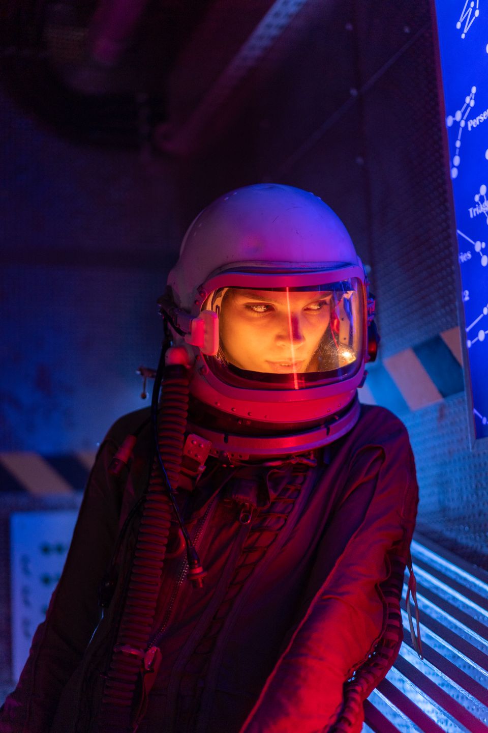 Adult wearing a futuristic space suit in neon light