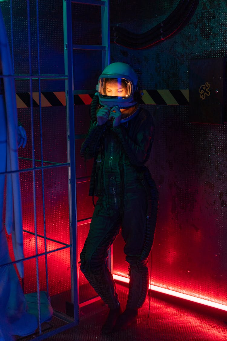 Woman In Spacesuit Standing Near A Ladder