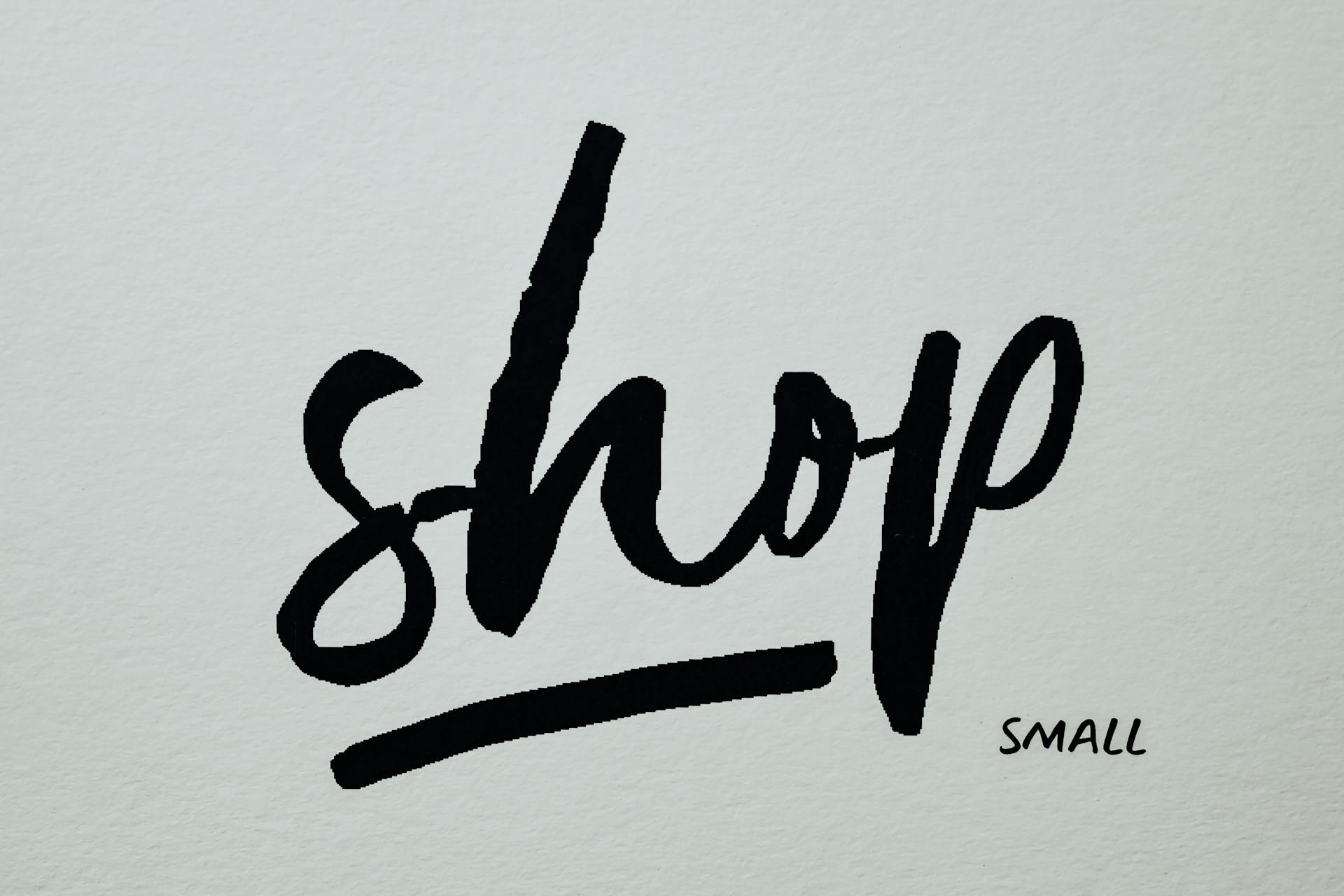 Handwritten black text on a white background promoting small business shopping.