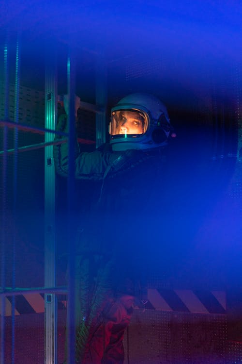 Woman In Spacesuit Standing On A Ladder