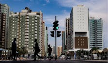 People Walking on the Sidewalk with Traffic Lights