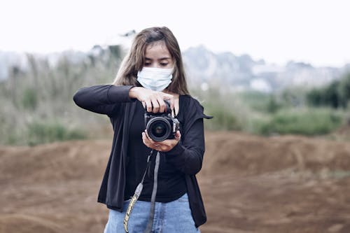 Woman in Black Jacket Holding a Camera