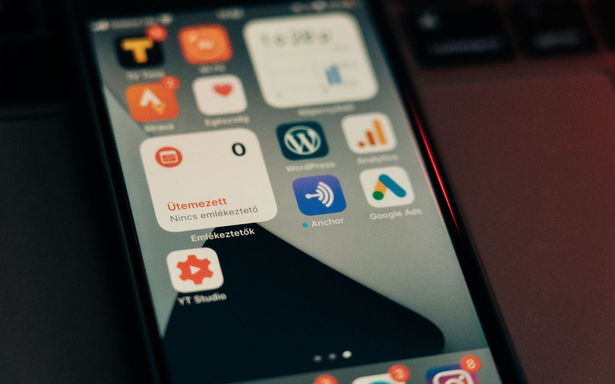 Close-up view of smartphone screen showing various app icons and notifications