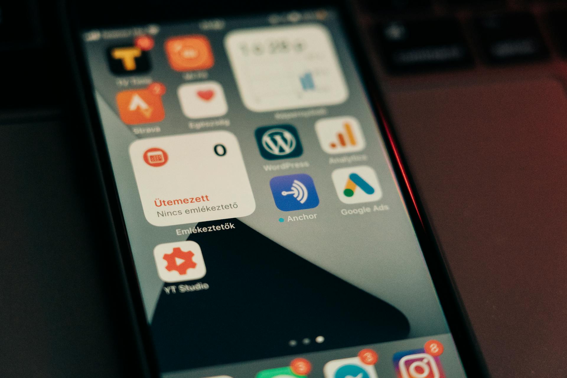 Close-up view of smartphone screen featuring various app icons and notifications.