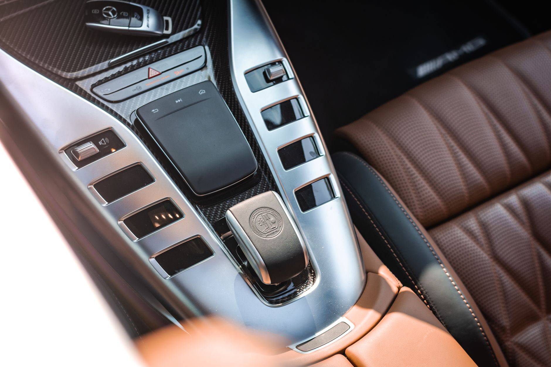 Close-up view of a luxurious car interior highlighting the sleek console and leather seats.