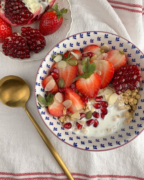 Sliced Strawberries on White and Blue Ceramic Bowl