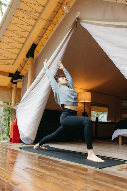 Woman in Long Sleeve Shirt and Black Leggings Doing Yoga